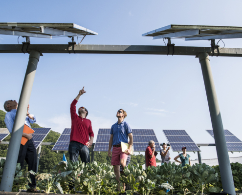 August 29, 2018 - NREL researcher Jordan Macknick and Michael Lehan discuss panel orientation and spacing. Macknick is working with teams from UMass Clean Energy Extension and Hyperion on a photovoltaic dual-use research project at the UMass Crop Animal Research and Education Center in South Deerfield, MA. They are researching simultaneously growing crops under PV Arrays while producing electricity from the panels. The project is part of the DOE InSPIRE project seeking to improve the environmental compatibility and mutual benefits of solar development with agriculture and native landscapes. L-R Michael Lehan, Jordan Macknick, Anne Marley, Jake Marley, Dwayne Bregel, Kristin Oleskwwicz and Zara Dowling. (Photo by Dennis Schroeder / NREL)