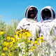 two women in beekeeper suits